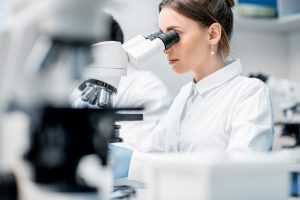 Medic working with microscope at the laboratory
