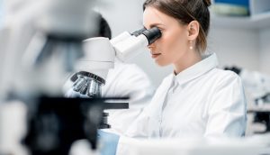Medic working with microscope at the laboratory